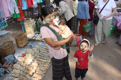 Mother, baby & child in market